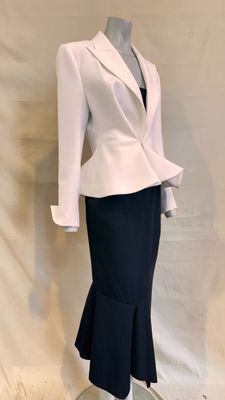 a mannequin wearing a white jacket and black skirt