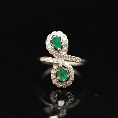 an emerald and diamond bypass ring