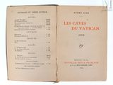 un livre ouvert, sur lequel figurent des inscriptions en rouge, posé sur une surface blanche