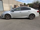 a picture of a silver car parked in front of a building