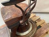 a old fashioned barber chair sitting on a pallet