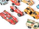 many toy cars that are lined up together on a white surface
