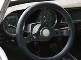 a steering wheel and dashboard of an old car