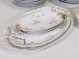 a lot of plates and bowls on the table
