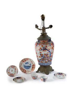 a vase with a lamp on top of it next to other items