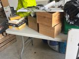 a table with a lot of books on it in a garage