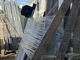 several pieces of wood are stacked on top of pallets in a warehouse