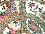 a plate with a design of flowers and birds on it