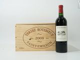 a bottle of wine sitting next to a wooden box