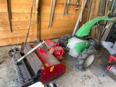 a lawn mower that is sitting in the garage