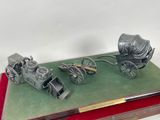 a model of a horse drawn carriage and a covered wagon