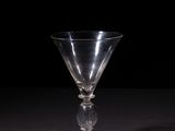 an empty wine glass sitting on top of a black table