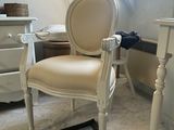 a white chair sitting in a room with a window