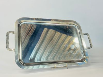 silver plated serving tray with handles and handles on a white surface