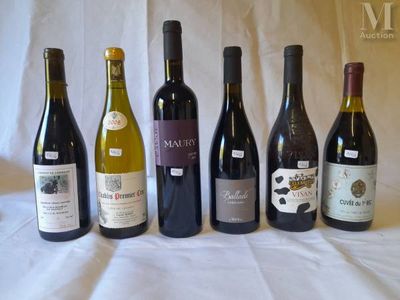 several bottles of wine are lined up in a row on a table