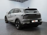 the rear end of a silver suv parked in a garage