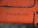 a close up of a rusted red piece of machinery