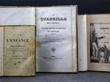 three old books sitting on top of a table next to each other