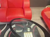 a red couch and a red chair in a living room