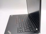 a black laptop with a red button on the keyboard