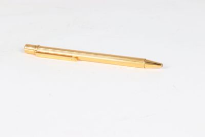 a pen that is laying on a white surface