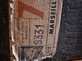 a piece of paper on the floor next to a brick wall