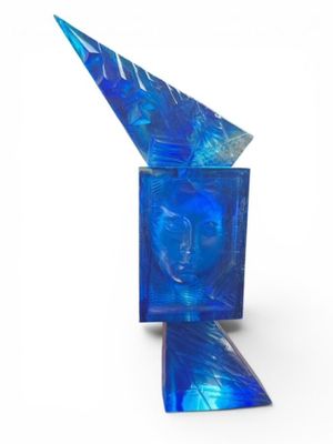an image of a blue glass sculpture with a face on it