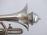a silver trumpet that is sitting on a table