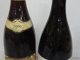 two bottles of wine sitting next to each other on a table
