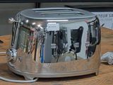 a toaster sitting on a table with a cord attached to it
