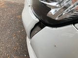 a close up of a car ' s headlight on the street