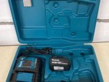 a blue tool case with a drill and two batteries in it