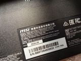 the back of a laptop with a sticker on it sitting on a plastic wrapper