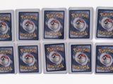 six pokemon trading cards with a red hat on top of them