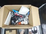 a cardboard box full of electronic equipment on the floor