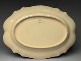an image of a white plate with a gold rim on a gray surface