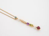 a gold necklace with multi colored stones and pearls