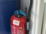 a red fire extinguisor attached to a blue door