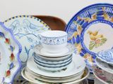 many plates and cups stacked on top of each other