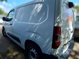 a white van that is parked on the side of the road