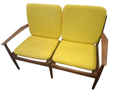 a pair of yellow chairs sitting next to each other on a white surface