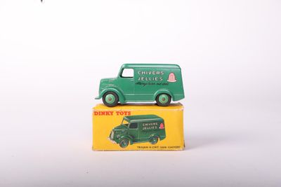 a green toy truck sitting on top of a yellow box
