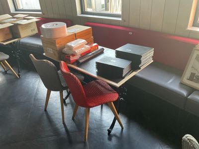 une table sur laquelle se trouvent de nombreuses boîtes, devant une fenêtre