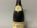 a bottle of red wine sitting on top of a table