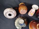 many different types of vases sitting on a table