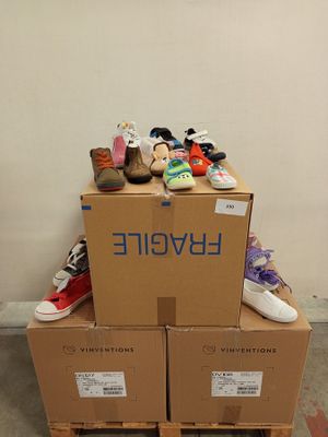 a pile of shoes sitting on top of a cardboard box