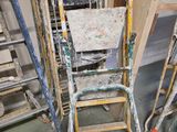 many ladders and chairs that are in a room