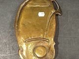gold plated coin purse with a coin inside of it on a table