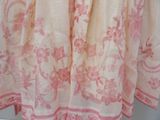 a pink and white dress hanging on a hanger