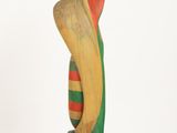 wooden sculpture of a woman with a hat on her head